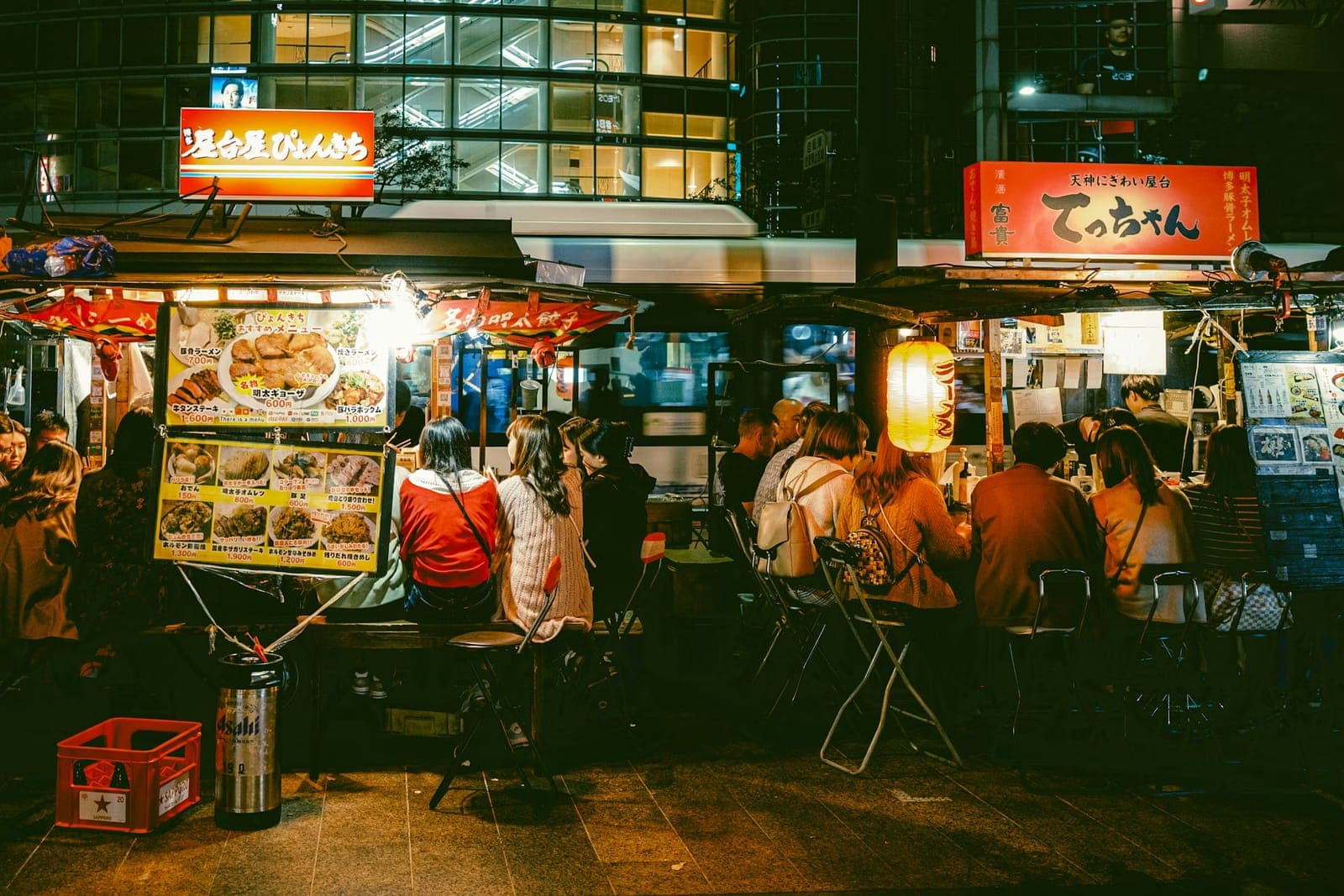 People eating at Fukuoka food stalls at night