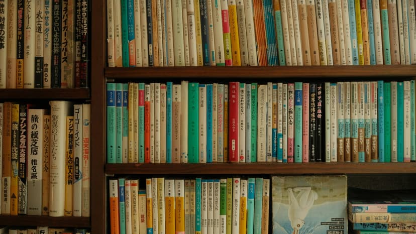Collection of Japanese language learning textbooks including Genki and Minna no Nihongo on a bookshelf